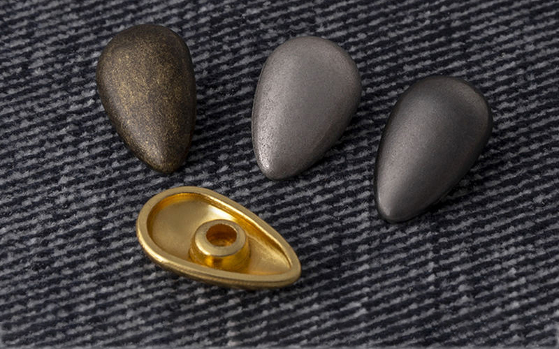 一枚撞钉的时尚宣言：为何顶尖品牌独爱AB亚洲钮扣的“水滴撞钉”与“棱角撞钉”？